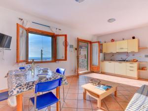 a kitchen and living room with a table and chairs at Apartment Giulia-2 by Interhome in Capoliveri