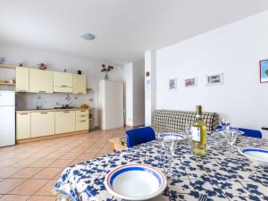 a kitchen and a dining table with a bottle of wine at Apartment Giulia-2 by Interhome in Capoliveri +33 photos