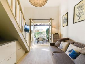 a living room with a couch and a staircase at Studio Mas de la Plage by Interhome in Cavalaire-sur-Mer +16 photos