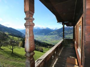 a balcony of a house with a view of mountains at Apartment Unterflöber-1 by Interhome in Großhartberg