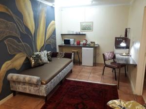 a living room with a couch and a table at Beit-El BnB in Polokwane