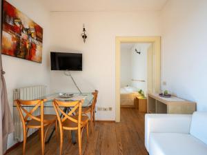 a living room with a dining room table and chairs at Apartment Vittoria by Interhome in Ghiffa