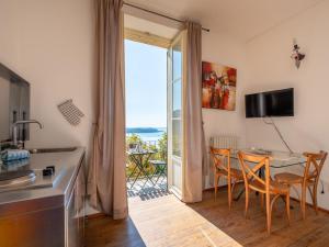 a kitchen and dining room with a table and chairs at Apartment Vittoria by Interhome in Ghiffa +12 photos