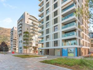 an apartment building on a street in a city at Apartment LocTowers A4-3-4 by Interhome in Locarno