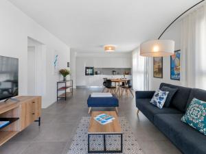 a living room with a couch and a table at Apartment LocTowers A4-3-4 by Interhome in Locarno +19 photos