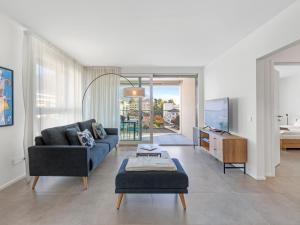 a living room with a couch and a table at Apartment LocTowers A3-3-3 by Interhome in Locarno +21 photos
