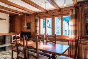 a dining room with a wooden table and chairs at Chalet Nucleo 12 by Quokka 360 - bouldering temple in Chironico in Chironico