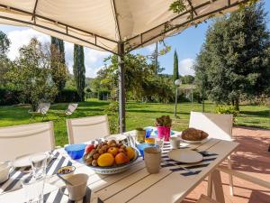a white table with a bowl of fruit on it at Holiday Home Pepi by Interhome in Gabellino