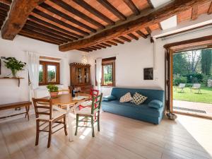 a living room with a blue couch and a table at Holiday Home Pepi by Interhome in Gabellino