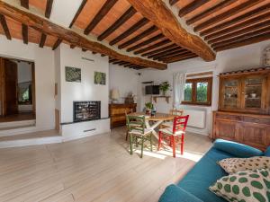 a living room with a blue couch and a table at Holiday Home Pepi by Interhome in Gabellino