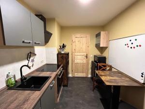 a kitchen with a sink and a refrigerator at Apartment Räuberhauptmann Karasek by Interhome in Hain