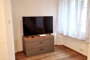 a flat screen tv on a dresser in a room at Appartment Wolf Huber im Zentrum der Altstadt. in Feldkirch