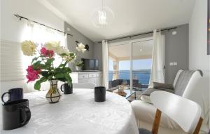 a living room with a table with flowers on it at Beautiful Home In Vela Luka With 2 Bedrooms And Jacuzzi in Vela Luka