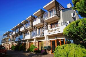 an apartment building with a sign that reads antwerp hotel at Amberia in Grzybowo