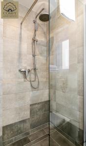 a shower with a glass door in a bathroom at Stare Miasto Gdańsk - Marina in Gdańsk