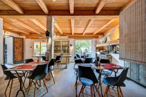 a kitchen and dining room with tables and chairs at Contact Hôtel Le Provence in Gémenos +43 photos