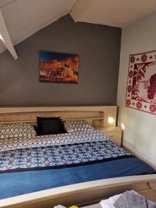 a bedroom with a bed with a laptop on it at Mevazara guesthouse in Malmedy