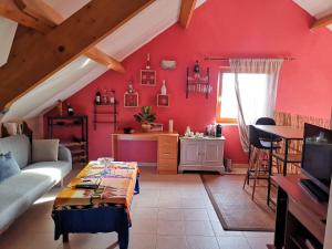 a red living room with a couch and a table at Mevazara guesthouse in Malmedy
