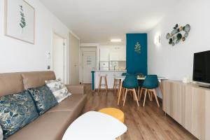 Televízia a/alebo spoločenská miestnosť v ubytovaní UHC Michelangelo Apartments