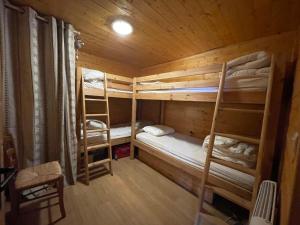 a room with two bunk beds in a cabin at Les Silènes pyrènes 2000 Meublé touristique 4 Etoiles in Bolquere Pyrenees 2000