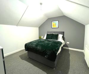 a bedroom with a large bed in a room at Chantry Suites in Grimsby