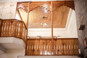 an ornate wooden staircase in a house at Tales N Trails in Vashisht +83 photos
