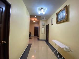 a hallway with a stairwell with a chair and a door at D'Village Batu Berendam, Melaka in Ayer Keroh
