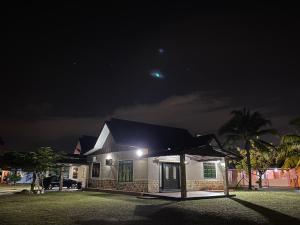 a house at night with the moon in the sky at D'Village Batu Berendam, Melaka in Ayer Keroh