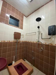 a bathroom with a toilet with a sink in it at D'Village Batu Berendam, Melaka in Ayer Keroh +13 photos