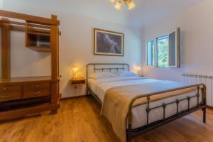 a bedroom with a bed and a dresser and window at Solar dos Reis by An Island Apart in Ribeira Brava