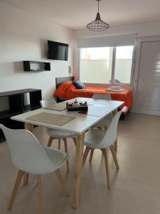 a living room with a table and chairs and a couch at APART trelew 5 in Trelew