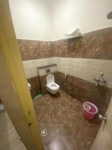 a dirty bathroom with a toilet and a sink at Dwivedi Hotels Sri Omkar Palace in Varanasi