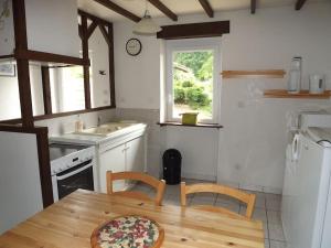a kitchen with a table and two chairs and a sink at Gîte Tucolet in Hinx