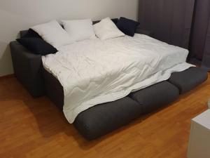 a large bed with white sheets and pillows on it at Edullinen majoitus Ähtärissä! in Ähtäri