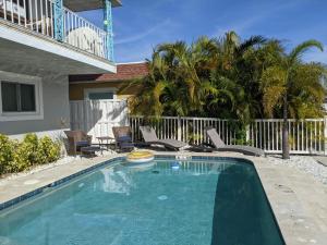 a swimming pool in front of a house at Waterfront & Pool Star5Vacations in St Pete Beach