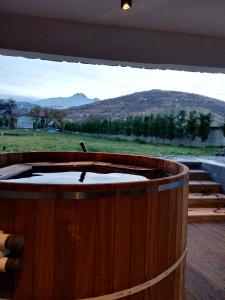 a wooden hot tub with a view of a mountain at Ultra Luxury Chalet near Cappadocia - up to 9 people in Kayseri