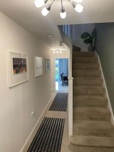 a hallway with a staircase in a house at The Townhouse @Thorpe Road in Peterborough