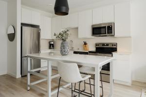 a white kitchen with a white table and chairs at Sonder at SECOND & SECOND in Minneapolis