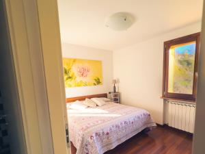 a bedroom with a bed and a painting on the wall at Tenuta MonteOliveto - Family Cottage - Agriturismo nelle Langhe in Vesime +29 photos