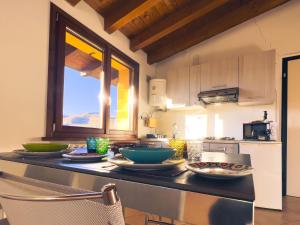 a kitchen with a counter with bowls and plates on it at Tenuta MonteOliveto - Family Cottage - Agriturismo nelle Langhe in Vesime
