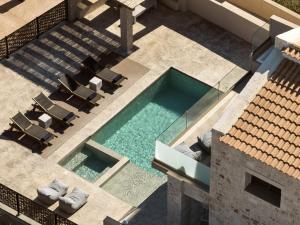 an overhead view of a swimming pool with chairs and a house at LaSoleil Villa, Zante Zen By ThinkVilla in Psarou