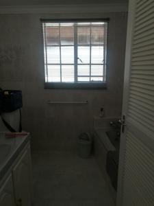 a bathroom with a tub and a toilet and a window at NJIRI LODGE - Your part of Africa in Marloth Park +32 photos
