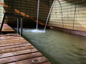 a stream of water coming out of a tunnel at Wadi Al-Hassa camp in Khawkhah