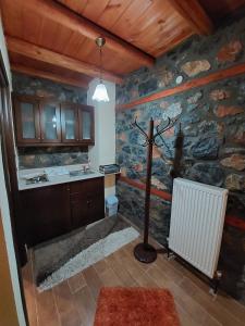 a room with a stone wall with a cross in it at Anesis Suites in Palaios Agios Athanasios