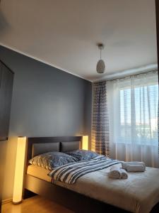 a bedroom with a bed with a window and a bed sidx sidx sidx at ALIZE in Reda +10 photos