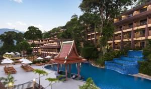 a hotel with a swimming pool and a resort at Chanalai Garden Resort, Kata Beach in Kata Beach