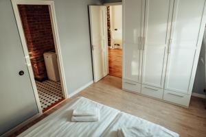 1 dormitorio con cama blanca y espejo en Central 1-bedroom Apartment with Bath & Balcony, en Tallin