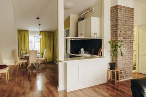 a living room with a kitchen and a dining room at Central 1-bedroom Apartment with Bath & Balcony in Tallinn