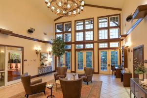 a living room with large windows and a chandelier at RiverStone Condo Resort & Spa in Pigeon Forge