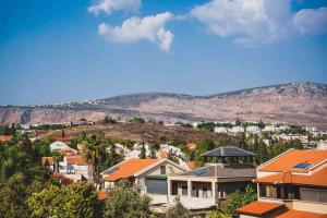 a city with houses and mountains in the background at Brand New Zippi`s- karmiel in Karmiel